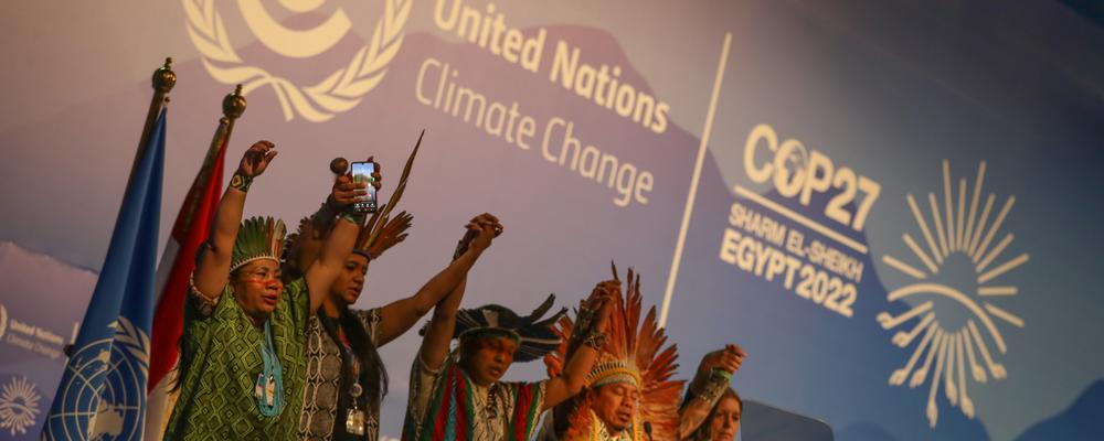 Indigenous people speaking on stage at COP27