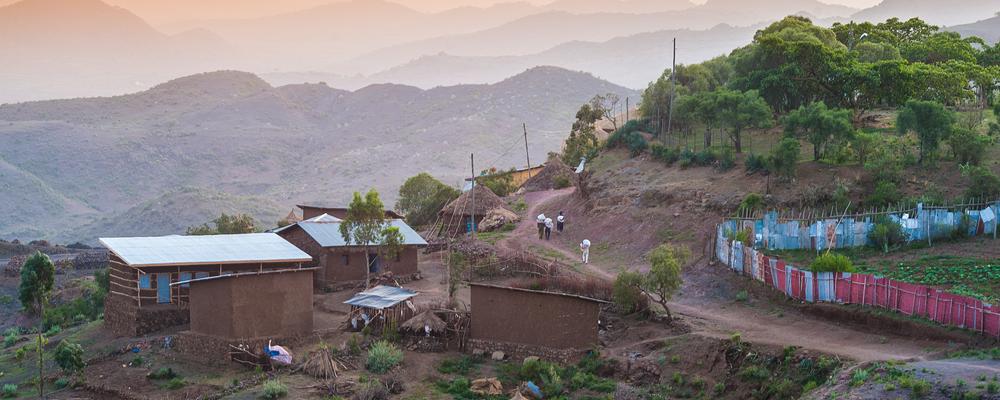 Landscape in rural Ethiopia showing small houses 
