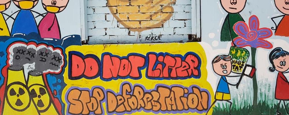 Graffiti on urban wall in Yangon saying do not litter and stop deforestation