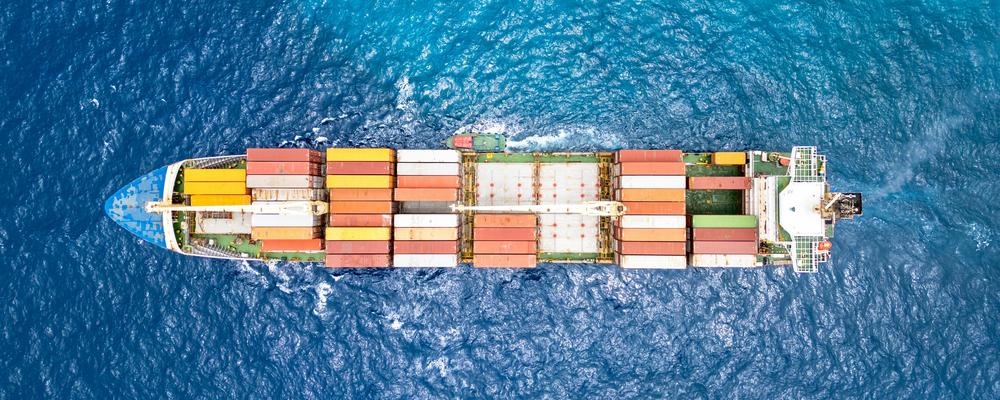 Picture showing a cargo ship with containers from above.