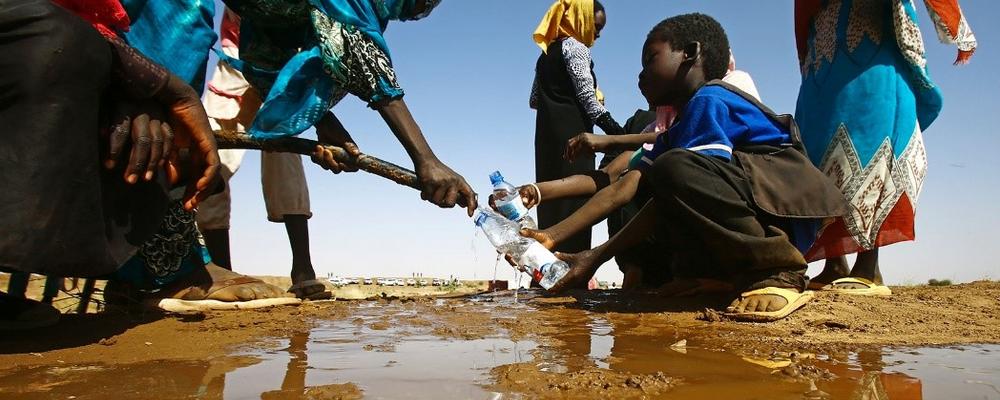 People at a water body. showing scacrity of water